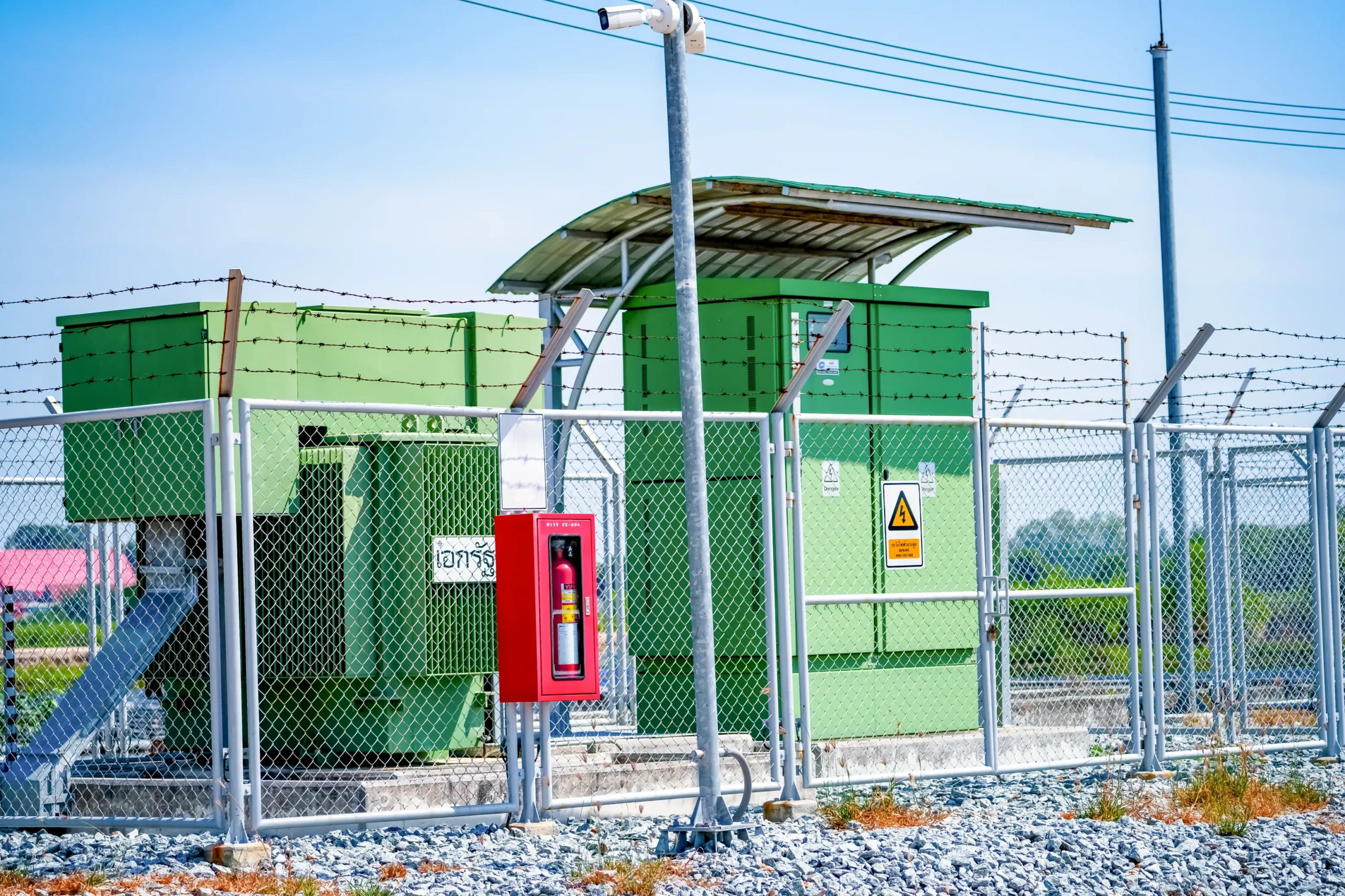 Utility scale solar photovoltaic array feeding inverter stations and medium voltage step-up transformers at the edge of a plant